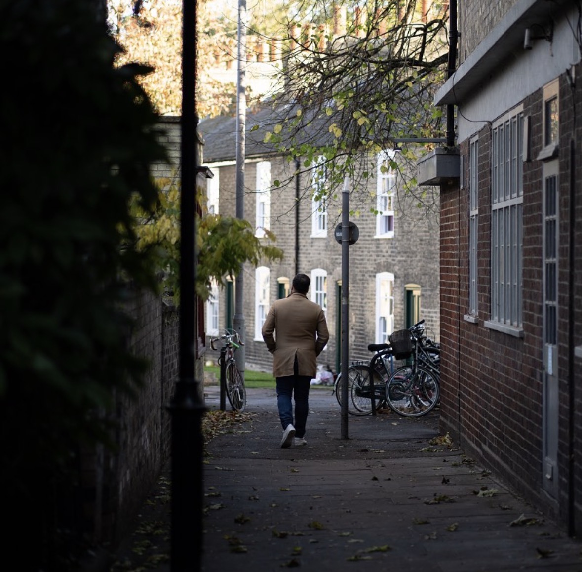 Jack, founder of Cambridge Food, walking down a historic Cambridge lane on a food review trip